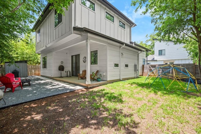 611 Gaylor St Unit 2, Austin, TX 78752 - rear view of property with board and batten siding, a patio area, and a fenced backyard