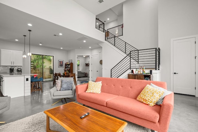 611 Gaylor St Unit 2, Austin, TX 78752 - living room with concrete flooring, stairs, recessed lighting, and a towering ceiling