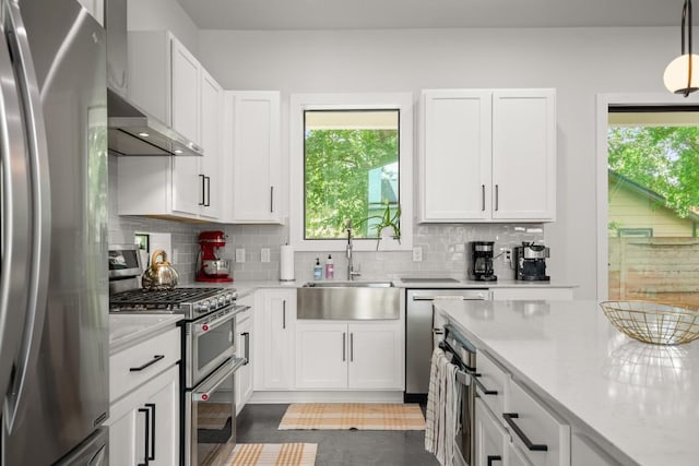 611 Gaylor St Unit 2, Austin, TX 78752 - kitchen with stainless steel appliances, extractor fan, and white cabinets