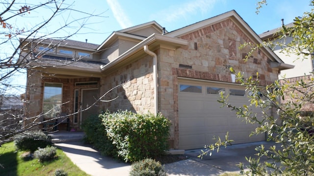 1024 Chad Loop, Round Rock, TX 78665 - view of side of property with stone siding, an attached garage, and concrete driveway