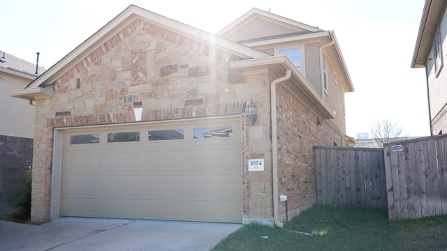 1024 Chad Loop, Round Rock, TX 78665 - view of property exterior featuring stone siding, driveway, and brick siding