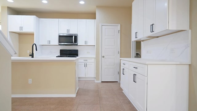 1024 Chad Loop, Round Rock, TX 78665 - kitchen featuring stainless steel microwave, range, recessed lighting, and white cabinets