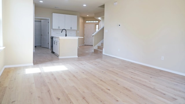 1024 Chad Loop, Round Rock, TX 78665 - kitchen featuring light countertops, recessed lighting, light wood-style floors, open floor plan, and white cabinetry