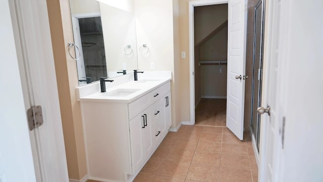1024 Chad Loop, Round Rock, TX 78665 - full bath with double vanity, tile patterned flooring, a shower with shower door, and a spacious closet