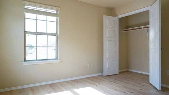 1024 Chad Loop, Round Rock, TX 78665 - unfurnished bedroom featuring multiple windows, light wood-style floors, and a closet