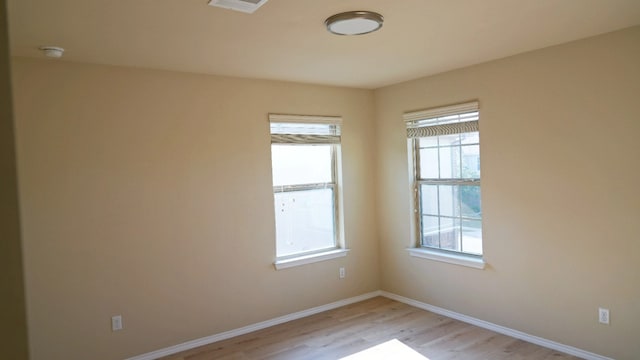 1024 Chad Loop, Round Rock, TX 78665 - spare room with light wood-style floors, healthy amount of natural light, and a smoke detector