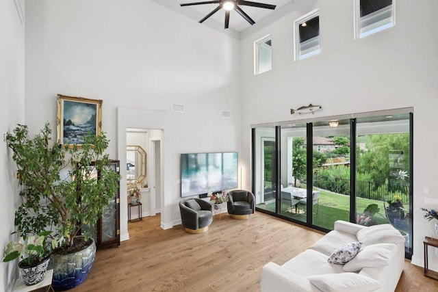 101 Cascading Water Pl, Austin, TX 78734 - living room with ceiling fan, a towering ceiling, wood finished floors, and healthy amount of natural light