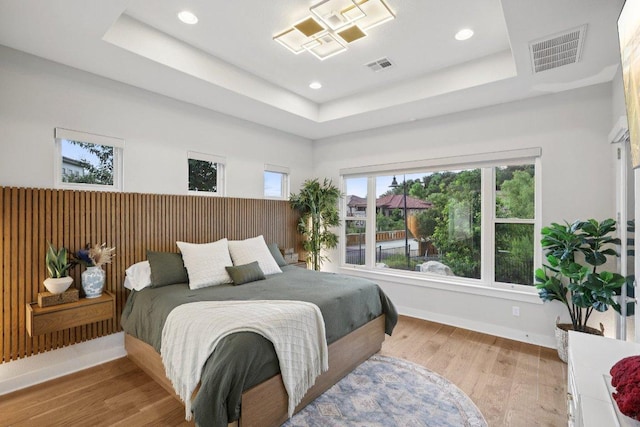 101 Cascading Water Pl, Austin, TX 78734 - bedroom with a raised ceiling, recessed lighting, and light wood-type flooring