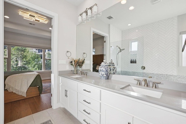 101 Cascading Water Pl, Austin, TX 78734 - bathroom featuring connected bathroom, double vanity, tile patterned flooring, a walk in shower, and recessed lighting