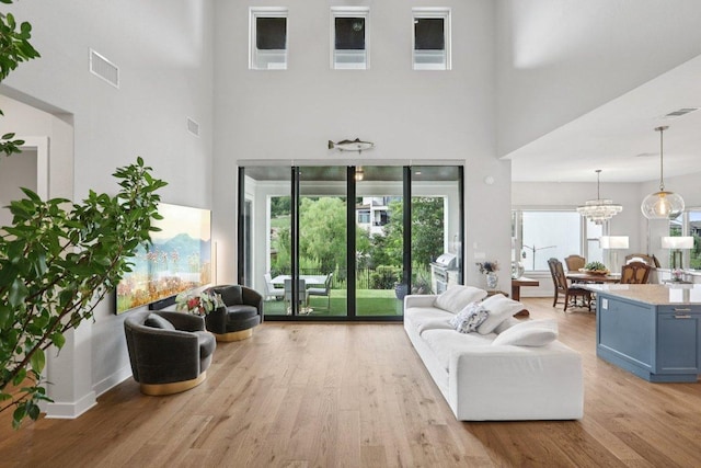 101 Cascading Water Pl, Austin, TX 78734 - living area with wood finished floors, a high ceiling, and a chandelier