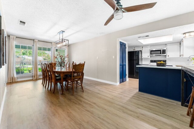 803 Lone Star Dr, Cedar Park, TX 78613 - dining area with a textured ceiling, light wood-style flooring, and ceiling fan