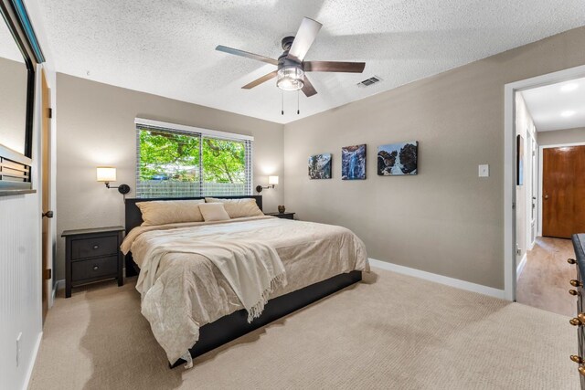 803 Lone Star Dr, Cedar Park, TX 78613 - bedroom featuring a textured ceiling, light colored carpet, and ceiling fan