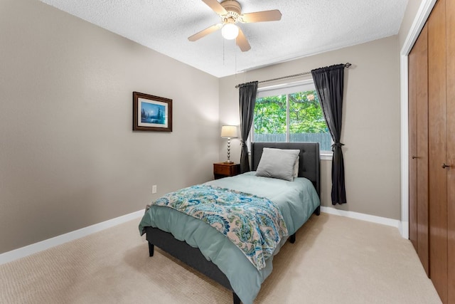 803 Lone Star Dr, Cedar Park, TX 78613 - bedroom with light colored carpet, a textured ceiling, a closet, and ceiling fan