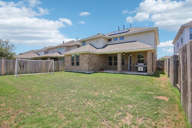 3200 Bravo Dr, Leander, TX 78641 - back of property with a patio area, a fenced backyard, solar panels, and brick siding