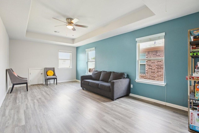3200 Bravo Dr, Leander, TX 78641 - living area with a tray ceiling, a ceiling fan, and wood finished floors