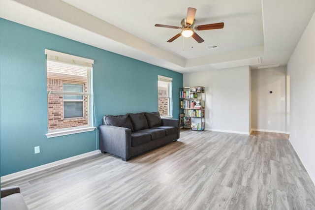 3200 Bravo Dr, Leander, TX 78641 - living area with wood finished floors, a raised ceiling, and ceiling fan