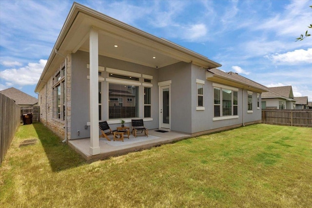 271 Eclipse Dr, Austin, TX 78737 - rear view of property featuring a patio area, a fenced backyard, stucco siding, and stone siding