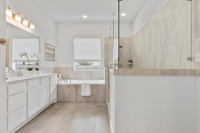 271 Eclipse Dr, Austin, TX 78737 - bathroom featuring a bath, vanity, a walk in shower, and recessed lighting