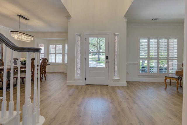 38 Cottondale Rd, The Hills, TX 78738 - entrance foyer featuring crown molding, light wood finished floors, and a chandelier