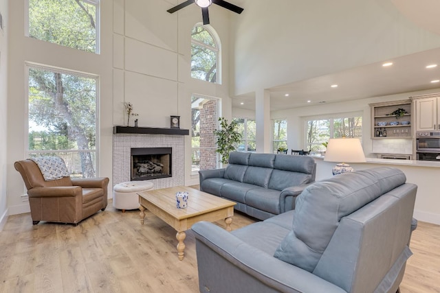 38 Cottondale Rd, The Hills, TX 78738 - living area featuring a towering ceiling, ceiling fan, light wood-style floors, recessed lighting, and a fireplace