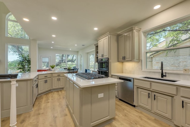 38 Cottondale Rd, The Hills, TX 78738 - kitchen with appliances with stainless steel finishes, a kitchen island, plenty of natural light, light countertops, and recessed lighting