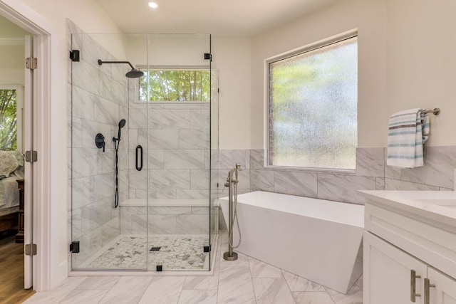 38 Cottondale Rd, The Hills, TX 78738 - full bathroom featuring a soaking tub, a shower stall, vanity, recessed lighting, and tile walls