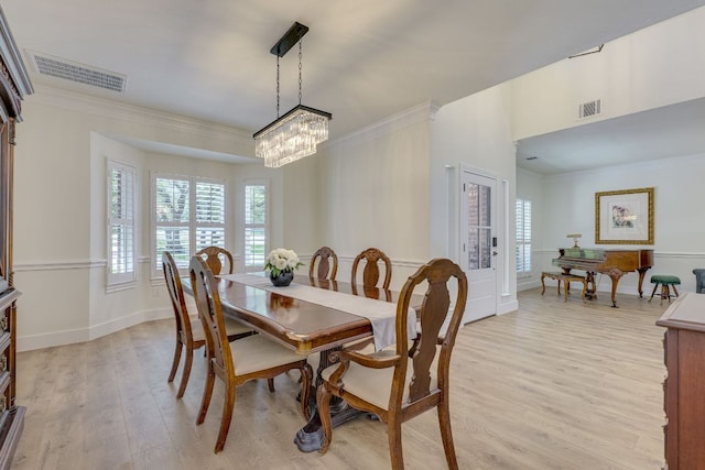38 Cottondale Rd, The Hills, TX 78738 - dining area featuring light wood-style flooring, a chandelier, and crown molding