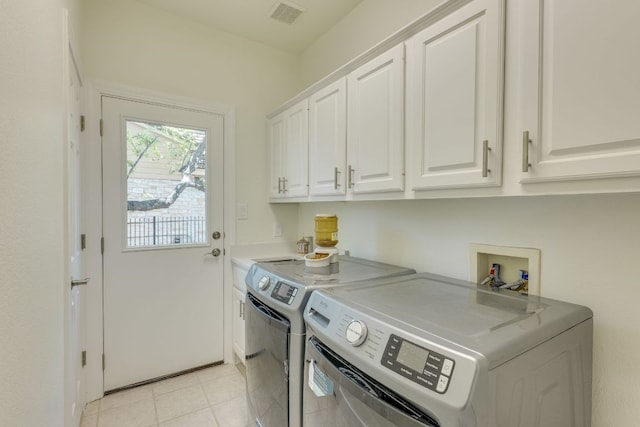38 Cottondale Rd, The Hills, TX 78738 - laundry area with cabinet space, washer and dryer, and light tile patterned flooring