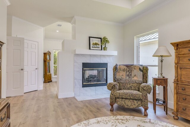38 Cottondale Rd, The Hills, TX 78738 - sitting room featuring light wood finished floors, crown molding, and a fireplace