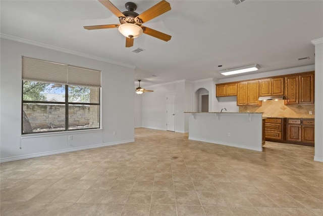 4921 Big Bend Trl, Georgetown, TX 78633 - unfurnished living room with a ceiling fan, crown molding, and arched walkways