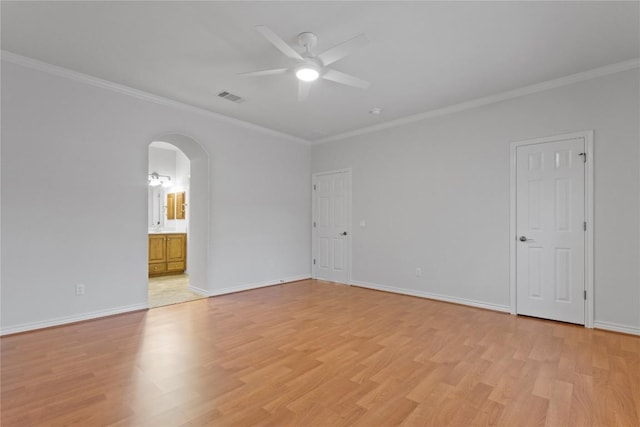 4921 Big Bend Trl, Georgetown, TX 78633 - empty room featuring ceiling fan, crown molding, arched walkways, and light wood-type flooring