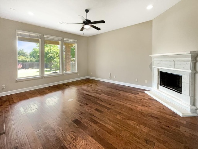 2302 Ponderosa Pass, Cedar Park, TX 78641 - unfurnished living room featuring dark wood finished floors, a ceiling fan, a fireplace with raised hearth, and recessed lighting