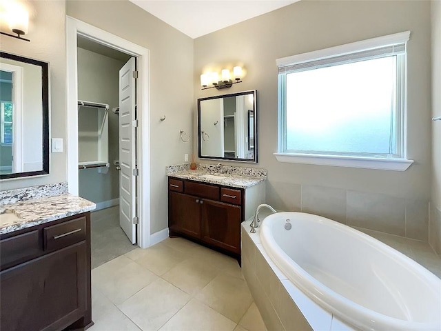 2302 Ponderosa Pass, Cedar Park, TX 78641 - full bathroom featuring a garden tub, two vanities, plenty of natural light, and tile patterned flooring
