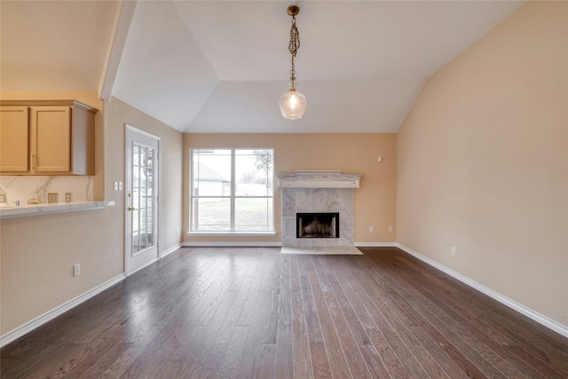 233 Thomas Dr, Martindale, TX 78655 - unfurnished living room with lofted ceiling, dark wood-style floors, and a premium fireplace
