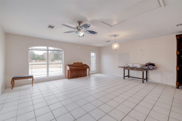 233 Thomas Dr, Martindale, TX 78655 - empty room with attic access, ceiling fan, and light tile patterned floors