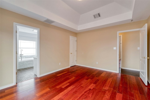 233 Thomas Dr, Martindale, TX 78655 - empty room with a tray ceiling and wood finished floors