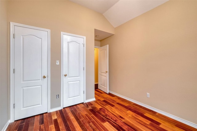 233 Thomas Dr, Martindale, TX 78655 - unfurnished bedroom featuring dark wood-style flooring and vaulted ceiling