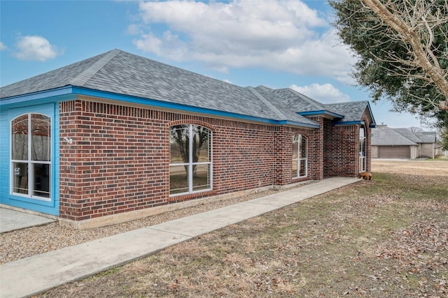 233 Thomas Dr, Martindale, TX 78655 - view of side of property with brick siding and a shingled roof