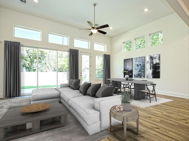 402 Zennia St, Austin, TX 78751 - living room with a ceiling fan, recessed lighting, wood finished floors, and a towering ceiling