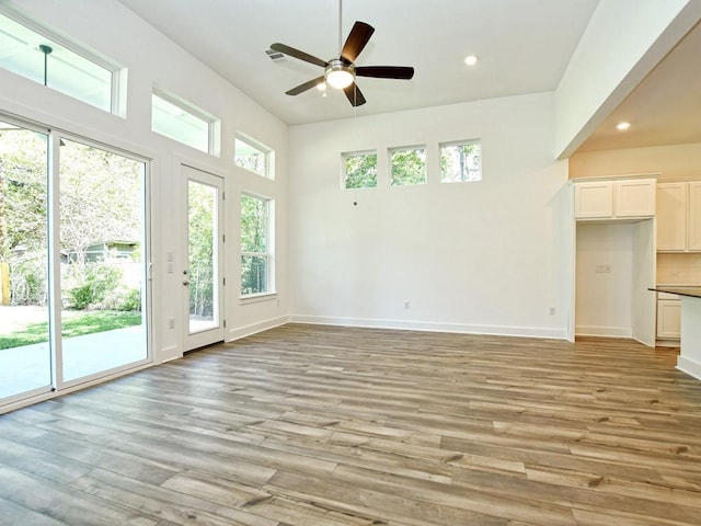 402 Zennia St, Austin, TX 78751 - unfurnished living room with a ceiling fan, recessed lighting, and light wood finished floors