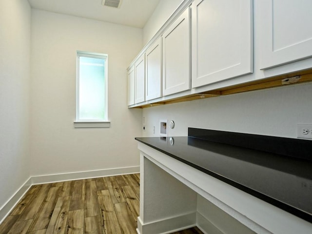 402 Zennia St, Austin, TX 78751 - laundry room featuring cabinet space, dark wood-style flooring, hookup for a washing machine, and electric dryer hookup