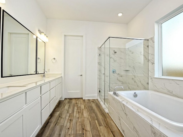 402 Zennia St, Austin, TX 78751 - bathroom featuring a bath, a marble finish shower, double vanity, and wood finished floors