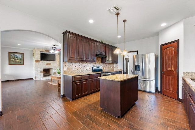 108 Whispering Pines Dr, Bastrop, TX 78602 - kitchen with stainless steel appliances, a ceiling fan, tasteful backsplash, dark brown cabinets, and dark wood-style flooring
