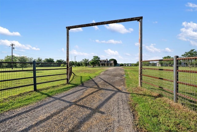 108 Whispering Pines Dr, Bastrop, TX 78602 - view of dirt / gravel driveway featuring a gated entry