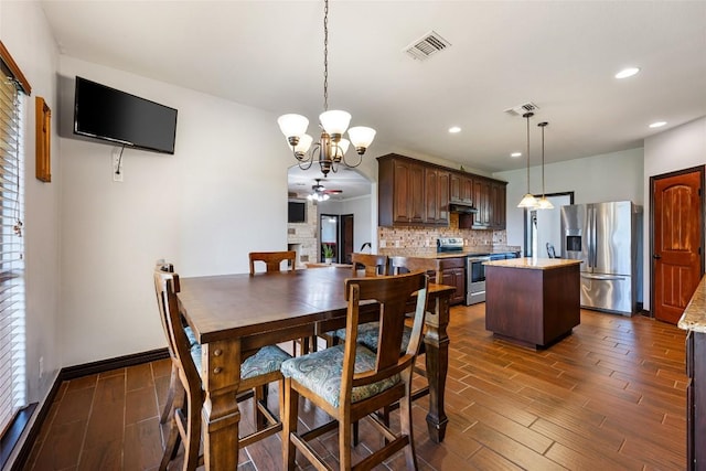 108 Whispering Pines Dr, Bastrop, TX 78602 - dining room featuring wood tiled floors, a chandelier, ceiling fan, and recessed lighting