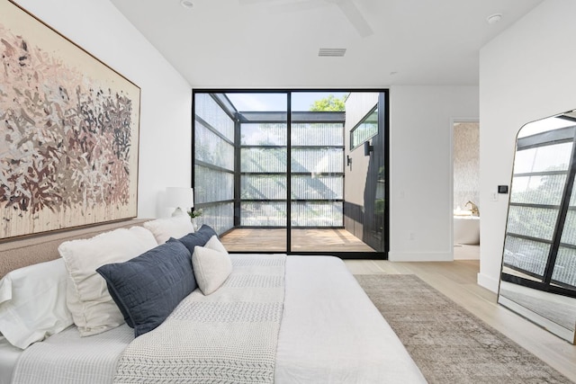 2701 Greenlee Dr, Austin, TX 78703 - bedroom with floor to ceiling windows, wood finished floors, and connected bathroom