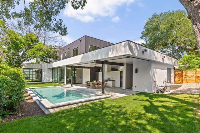 2701 Greenlee Dr, Austin, TX 78703 - back of property with stucco siding, a patio area, and an outdoor pool
