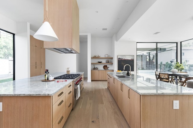 2701 Greenlee Dr, Austin, TX 78703 - kitchen with high end stove, light brown cabinets, modern cabinets, a large island, and light wood-style floors