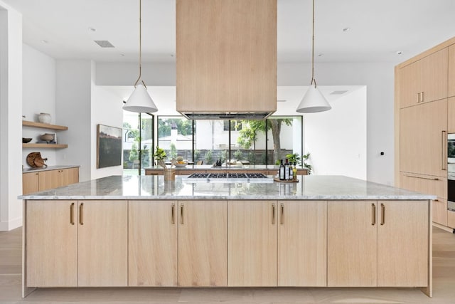 2701 Greenlee Dr, Austin, TX 78703 - kitchen with light brown cabinetry, light stone countertops, open shelves, and modern cabinets