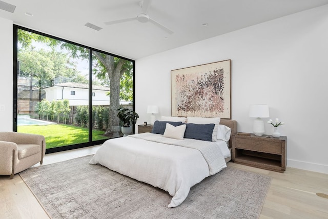 2701 Greenlee Dr, Austin, TX 78703 - bedroom featuring a wall of windows, light wood finished floors, and a ceiling fan
